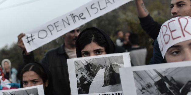 TOPSHOT - Refugees and migrants protest outside the Moria detention center in Mytilene on November 14, 2017, demanding to be released from the Greek island of Lesbos. / AFP PHOTO / ARIS MESSINIS (Photo credit should read ARIS MESSINIS/AFP/Getty Images)