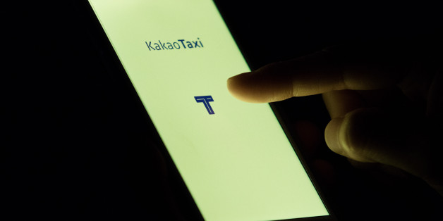 The KakaoTaxi application, developed by Daum Kakao Corp., is displayed on the screen of a mobile device in this arranged photograph in Seoul, South Korea, on Tuesday, June 2, 2015. Daum Kakao may take its two-month-old KakaoTaxi app overseas, with New York among the cities being considered, according to John Jung, director of business development, who said a decision hasn't been made. Photographer: SeongJoon Cho/Bloomberg via Getty Images