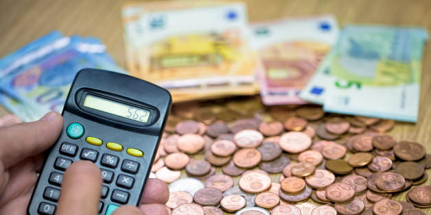 Monthly Expense Calculation- Close-up of man's hand using calculator to calculate expenses.es.