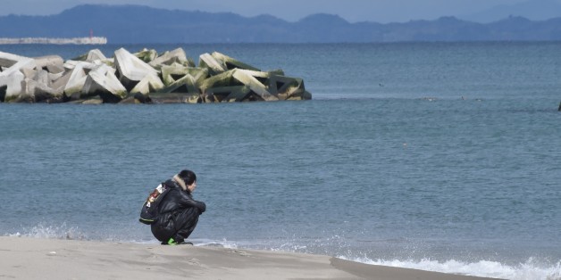 A man visits the seashore in Sendai's Arahama area, Miyagi prefecture on March 11, 2017 to pray for victims of the 2011 quake-tsunami disaster.
Japan is marking on March 11 the sixth anniversary of the magnitude 9.0 quake which struck under the Pacific Ocean and the ensuing tsunami which left about 18,500 people dead or missing. / AFP PHOTO / KAZUHIRO NOGI (Photo credit should read KAZUHIRO NOGI/AFP/Getty Images)