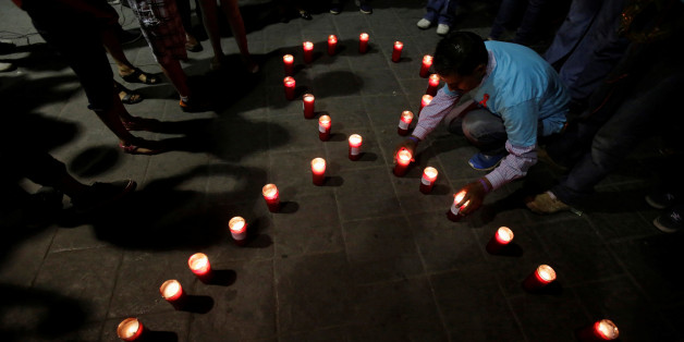 Members of Mexico's HIV/AIDS social organizations light candles during a vigil under the slogan "Two nations, One Heart" to remember those killed by HIV/AIDS and deliver prevention measures to citizens over the Santa Fe international bridge, which connects Ciudad Juarez to El Paso, Texas, in Ciudad Juarez, Mexico, May 21, 2017. REUTERS/Jose Luis Gonzalez