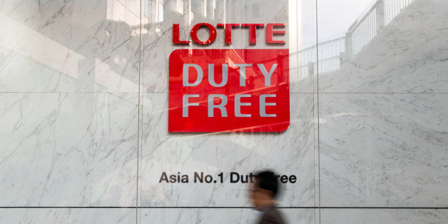 A man walks past signage for a Hotel Lotte Co. Duty Free store in Seoul, South Korea, on Monday, March 13, 2017. After almost seven years of planning and 4 trillion won ($3.6 billion) in spending, Lotte Group is preparing to unwrap its Lotte World Tower to the public. The building boasts some record-setting amenities: highest glass floor at the top of a building and highest swimming pool. Photographer: SeongJoon Cho/Bloomberg via Getty Images