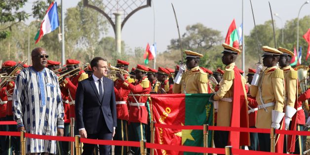 French President Emmanuel Macron (R) and Burkina Faso's President Roch Marc Christian Kabore review an honour guard at the Presidential Palace in Burkina Faso on November 28, 2017. / AFP PHOTO / POOL / LUDOVIC MARIN (Photo credit should read LUDOVIC MARIN/AFP/Getty Images)
