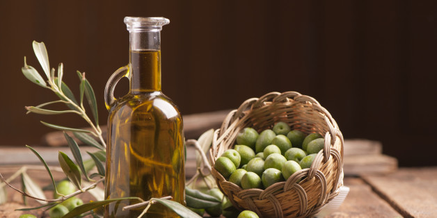 Olive oil and olives on wooden rustic table