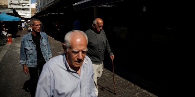People walk at the main food market in central Athens, Greece, May 22, 2017. REUTERS/Costas Baltas