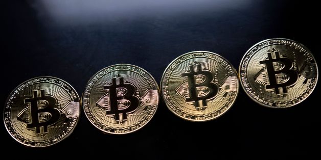 Gold plated souvenir Bitcoin coins are arranged for a photograph in London on November 20, 2017. Bitcoin, a type of cryptocurrency, uses peer-to-peer technology to operate with no central authority or banks. Bitcoin's recent rise and booming investor interest is forcing the regulatory and stock market authorities to formulate an official position on bitcoin and other virtual currencies, which are controversial not only because of their speculative nature, but are also seen as vehicles for illega