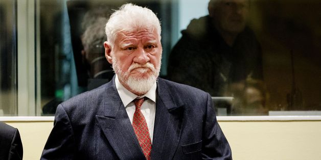 Croatian former general Slobodan Praljak stands prior to the start of his appeal judgement at the International Criminal Tribunal for the former Yugoslavia (ICTY) on November 29, 2017 at the Hague international court, in the court's final verdict for war crimes committed during the break-up of Yugoslavia.
Praljak, 72, appeared to drink poison seconds after judges upheld his 20-year sentence. He shouted out angrily 'Praljak is not a criminal' then drank from a small brown bottle. The hearing was quickly suspended as his lawyer shouted out 'my client says he has taken poison.'
/ AFP PHOTO / ANP AND POOL / Robin van Lonkhuijsen (Photo credit should read ROBIN VAN LONKHUIJSEN/AFP/Getty Images)