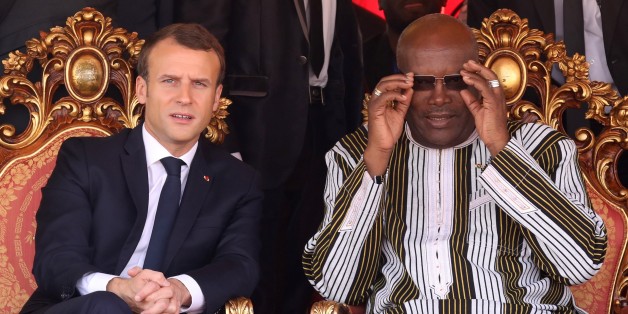 French president Emmanuel Macron (L) speaks with Burkina Faso's President Roch Marc Christian Kabore attend the inauguration ceremony of the solar energy power plant in Zaktubi, near Ouagadougou, on november 29, 2017, on the second day of his first African tour since taking office. / AFP PHOTO / POOL / LUDOVIC MARIN (Photo credit should read LUDOVIC MARIN/AFP/Getty Images)