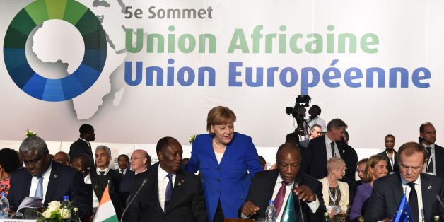 German Chancellor Angela Merkel (C) arrives to greet Ivory Coast's President Alassane Ouattara (2L) and Guinea's President and African Union (AU) chairman Alpha Conde (2R) next to African Union (AU) Commission chairman Moussa Faki (L) and European Council President Donald Tusk during the 5th African Union - European Union (AU-EU) summit in Abidjan, on November 29, 2017.Ivory Coast President opened a Europe-Africa summit on November 29, calling for 'all urgent measures' to end migrant abuses, inc