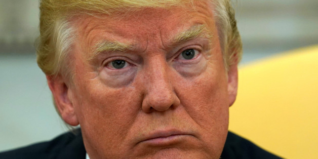 U.S. President Donald Trump looks up as reporters ask questions about the future of U.S. Secretary of State Rex Tillerson in the Oval Office at the White House in Washington, U.S., November 30, 2017. REUTERS/Kevin Lamarque