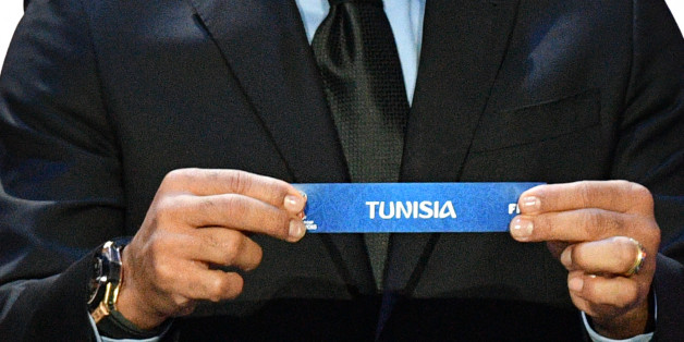 Brazil's former defender Cafu displays the slip of Tunisia during the Final Draw for the 2018 FIFA World Cup football tournament at the State Kremlin Palace in Moscow on December 1, 2017.The 2018 FIFA World Cup will be held from June 14 and July 15, 2018, in 11 Russian cities. / AFP PHOTO / Mladen ANTONOV (Photo credit should read MLADEN ANTONOV/AFP/Getty Images)
