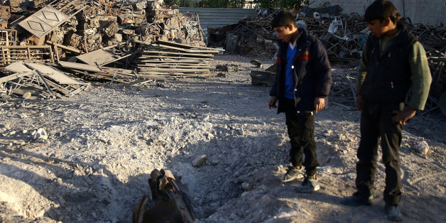 A boy reacts at a damaged site in the town of Hamoria, eastern Ghouta in Damascus, Syria, November 29, 2017. REUTERS/Bassam Khabieh
