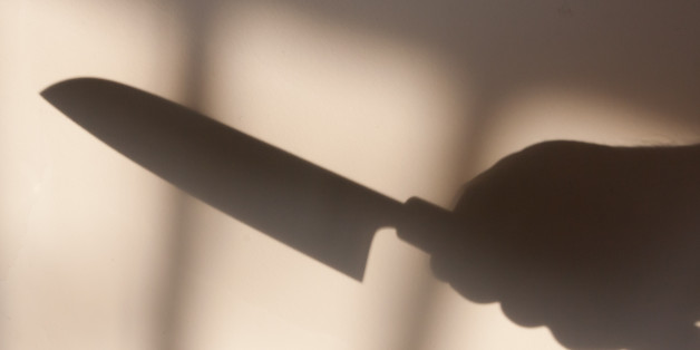 shadow of a hand holding a kitchen knife