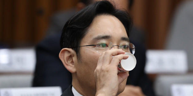 Jay Y. Lee, co-vice chairman of Samsung Electronics Co., takes a drink during a parliamentary hearing at the National Assembly in Seoul, South Korea, on Tuesday, Dec. 6, 2016. Lee, the de-facto head of Samsung, became the focus of the hearing of South Korea's top tycoons in connection with a widening influence-peddling scandal that may cost the country's president her job. Photographer: SeongJoon Cho/Bloomberg via Getty Images