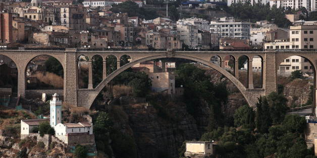 People cross over a bridge in the eastern city of Constantine June 21, 2012. REUTERS/Zohra Bensemra (ALGERIA - Tags: CITYSPACE)