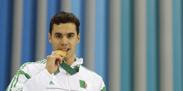 Algeria's Oussama Sahnoune (gold) poses after the Men's Swimming 50m Freestyle final during the Baku 2017 4th Islamic Solidarity Games at the Baku Aquatic Center on May 15, 2017.AFP PHOTO / BENJAMIN CREMEL/Baku 2017/AFP-Services (Photo credit should read BENJAMIN CREMEL/AFP/Getty Images)