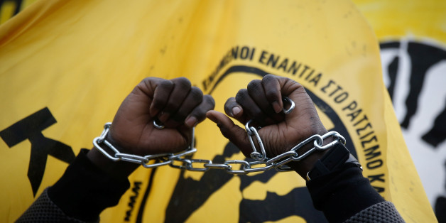 An African migrant living in Greece raises his chained hands during a protest against recent reports of migrant slavery in Libya, in Athens, Greece, December 2, 2017. REUTERS/Costas Baltas