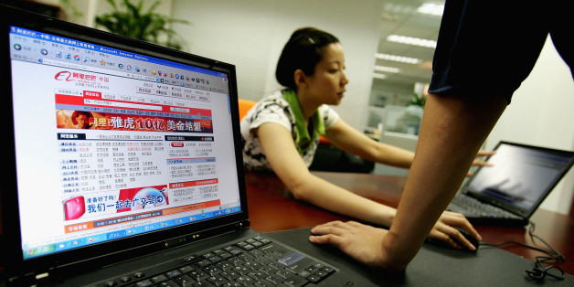 BEIJING - AUGUST 12: Wendy Li, vice director of business development department of Ali Baba works at the office of Alibaba (China) technology Co., Lth on August 12, 2005 in Beijing, China. Yahoo Inc. signed a deal to buy 40 percent of Alibaba.com for EUS 1 billion cash while handing over the running of its China operations to the Chinese online retailer in the biggest investment by a foreign company to gain access to China's 100 million net users. The deal creates an e-commerce giant, with the