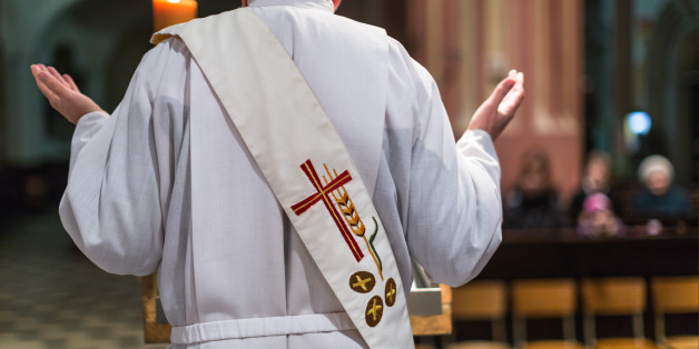 Priest during a ceremony in a church, celebrating a mass