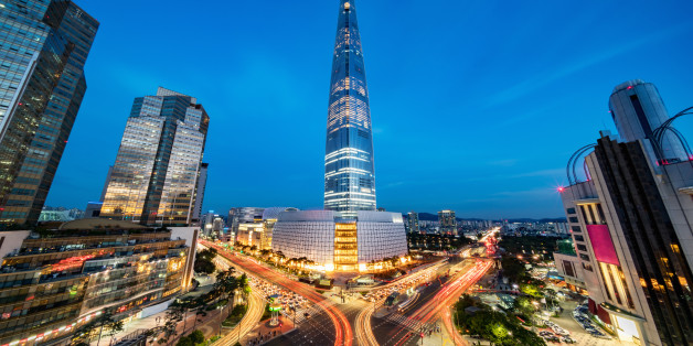 Cityscape of Songpagu district in Seoul at night. Motion blurred traffic lights, illuminated skyscrapers and Lotte world tower. Seoul, South Korea, Asia. Aerial view with 10 mm ultra wide angle 42 MP Sony A7RII.