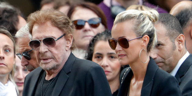 French singer and actor Johnny Hallyday (L) and his wife Laeticia attend the funeral ceremony of late actress Mireille Darc at the Saint-Sulpice church in Paris, France, September 1, 2017. REUTERS/Charles Platiau