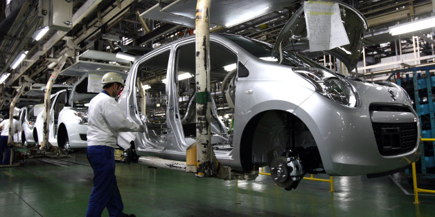 An employee works near a Suzuki Motor Corp. Swift vehicle on the assembly line at the company's Kosai Plant in Kosai City, Shizuoka prefecture, Japan, on Friday, March 12, 2010. Suzuki Motor Corp., Japan's second-largest minicar maker, raised its net income forecast last month on growing sales in India. Photographer: Tomohiro Ohsumi/Bloomberg via Getty Images