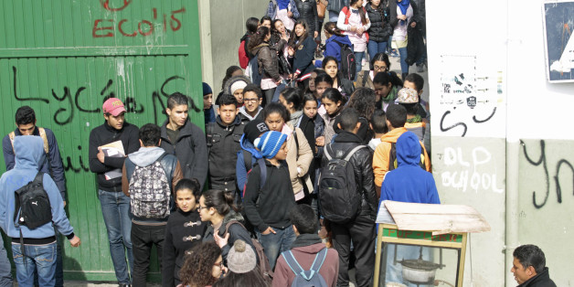 Students walk out of Sadiki high school as teachers go on strike in Tunis March 2, 2015. Tunisia's main teachers' union launched a week-long strike on Monday to demand pay hikes in another challenge to the recently installed government, which is trying to curb state spending and reduce fiscal deficit as required by international lenders. REUTERS/Zoubeir Souissi (TUNISIA - Tags: EDUCATION CIVIL UNREST SOCIETY POLITICS)