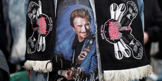 A fan of late French singer and actor Johnny Hallyday talks to journalists in Marnes-la-Coquette near Paris, France December 6, 2017. REUTERS/Benoit Tessier