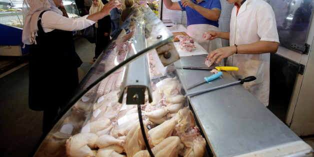 A customer buys chicken at a market in Algiers, Algeria October 15, 2017. Picture taken October 15, 2017. REUTERS/Ramzi Boudina
