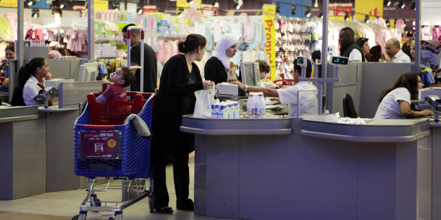Customers shop at a supermarket in Tunis November 12, 2012. Tunisia's central bank has clamped down on a consumer loan boom - a step that may be prudent economically but risks angering many Tunisians struggling with unemployment and poverty, and could have political implications. Picture taken November 12, 2012. To match story TUNISIA-BANKS/CONSUMER REUTERS/Zoubeir Souissi (TUNISIA - Tags: BUSINESS)
