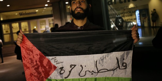 NEW YORK, USA - DECEMBER 6 : A student holds a Palestinian flag during a protest against the US President Donald Trumps recognition of Jerusalem as Israels capital, in Manhattan borough of New York, United States on December 6, 2017. (Photo by Mohammed Elshamy/Anadolu Agency/Getty Images)