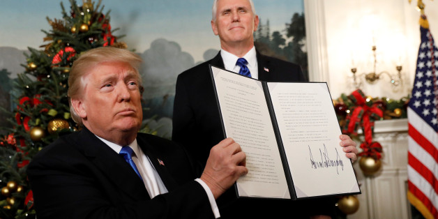 After signing, U.S. President Donald Trump holds up the proclamation that the United States recognizes Jerusalem as the capital of Israel and will move its embassy there, during an address from the White House in Washington, U.S., December 6, 2017. REUTERS/Kevin Lamarque