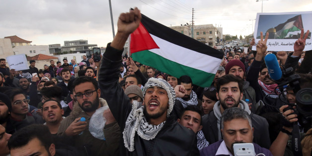 Protesters shout slogans and wave the Jordanian flag during a protest near the American Embassy in Amman against US President Donald Trump's decision to recognise Jerusalem as the capital of Israel on December 7, 2017. / AFP PHOTO / KHALIL MAZRAAWI (Photo credit should read KHALIL MAZRAAWI/AFP/Getty Images)