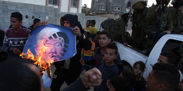 Palestinians burn posters of Israeli Prime Minister Benjamin Netanyahu and U.S. President Donald Trump, during a protest against the U.S. decision to recognize Jerusalem as Israel's capital, in Gaza City Thursday, Dec. 7, 2017. (Photo by Majdi Fathi/NurPhoto via Getty Images)