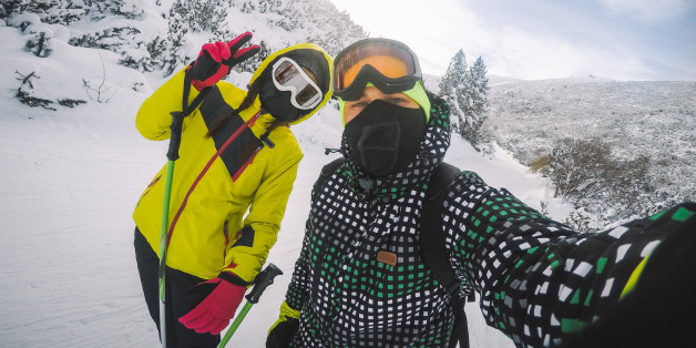 Skiers on the mountain, enjoying in skiing and making selfie