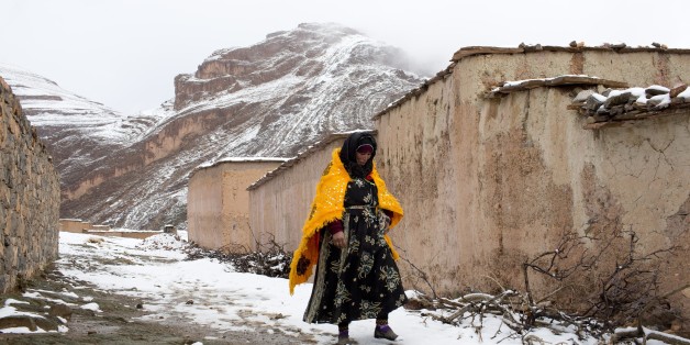 A woman walks through the snow covered village of Tilmi in the High Atlas region of Morocco February 13, 2015. The snowy foothills of the High Atlas mountains in Morocco are home to several Berber villages where the inhabitants make their living by farming, baking bread in traditional ovens, herding cattle, and the making and selling of honey, olive oil and pottery. Extreme weather fluctuations and erosion that causes flooding and landslides have led to a drop in agricultural productivity, the U