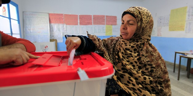 A Tunisian woman casts her ballot in the capital Tunis December 21, 2014. Tunisians began voting on Sunday in a presidential run-off election that completes the country's last steps to full democracy nearly fours years after an uprising that toppled autocrat Zine El-Abidine Ben Ali. REUTERS/Anis Mili (TUNISIA - Tags: POLITICS ELECTIONS)