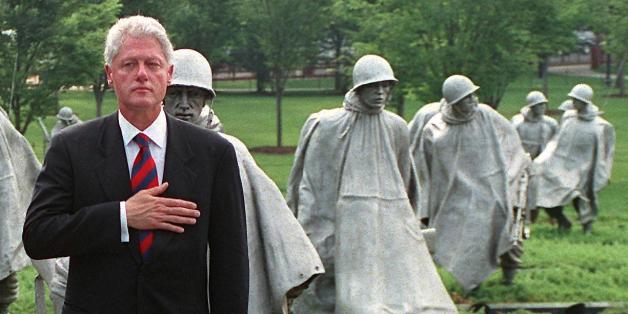 WASHINGTON, DC - JUNE 25: US President Bill Clinton (R) and South Korean ambassador to the US Hong-Koo Lee (L) hold their hands to their hearts during a commemorative ceremony at the Korean War Memorial 25 June 2000 in Washington, DC. On the 50th anniversary of the start of the conflict, Clinton hailed the 'forgotten' US soldiers of the Korean War, praising their 'indispensible' stand for freedom in the decisive early days of the Cold War. (Photo credit should read GEORGE BRIDGES/AFP/Getty I