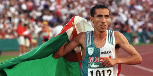 Noureddine Morceli carries the Algerian flag in a victory lap as he celebrates his gold medal win in the Men's 1500m final at Olympic Stadium August 3. Fermin-Cacho of-Spain won the silver medal and Stephen-Kipkorir won the bronze.