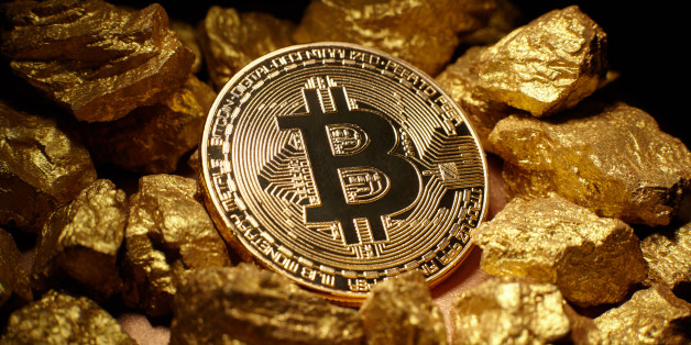 Berlin, Germany - July16, 2017: Golden Bitcoin Coin and mound of gold. Bitcoin cryptocurrency. Business concept.