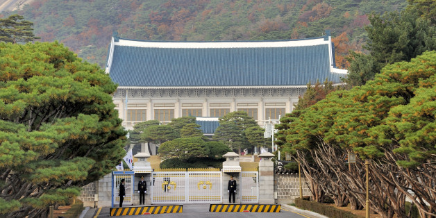 Seoul, South Korea- November 11, 2015: Security officials on duty at the front gate of South Korea presidential office. It is also known as The Blue House due to its blue color roof tiles. November 11, 2015 Seoul, South Korea.
