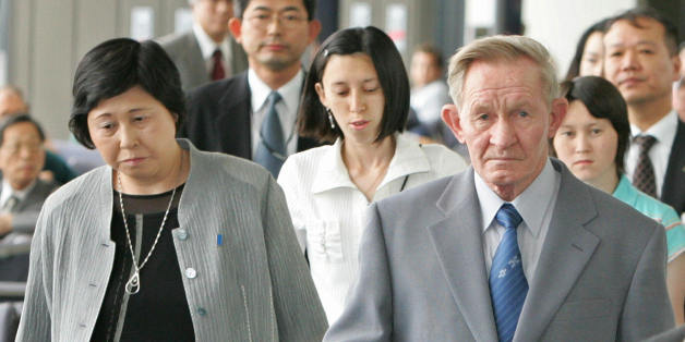 NARITA, JAPAN: Charles Jenkin (R) , the US soldier who deserted to North Korea in 1965, and his family members, wife Hitomi Soga (L), and their two North Korean-born daughters, Mika (rear 2nd L), Brinda (rear R), depart Narita Airport, Chiba Prefcture, 14 June 2005. Jenkins, 65, left Japan with his Japanese wife who he met in Pyongyang and their two North Korean-born daughters, on a commercial flight. AFP PHOTO/Kazuhiro NOGI (Photo credit should read KAZUHIRO NOGI/AFP/Getty Images)