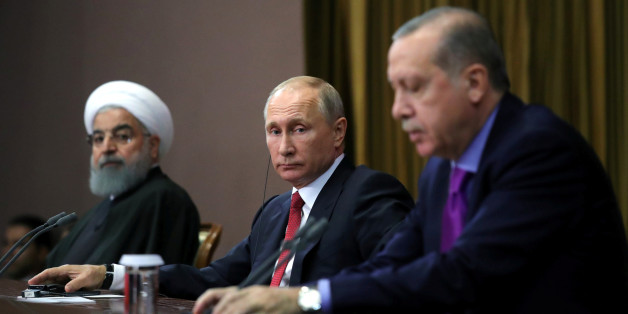 Iran's President Hassan Rouhani together with his counterparts Russia's Vladimir Putin and Turkey's Tayyip Erdogan attend a joint news conference following their meeting in Sochi, Russia November 22, 2017. Sputnik/Mikhail Klimentyev/Kremlin via REUTERS ATTENTION EDITORS - THIS IMAGE WAS PROVIDED BY A THIRD PARTY.