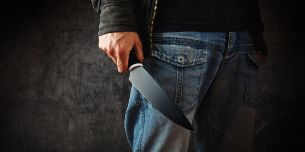 Evil man with shiny knife - a killer person with sharp knife about to commit a homicide, murder scenery.