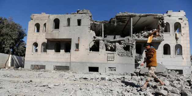 A Houthi militant walks by a Houthi-run detention center hit by air strikes in Sanaa, Yemen December 13, 2017. REUTERS/Khaled Abdullah