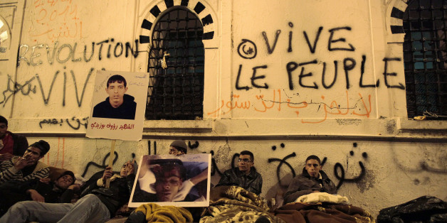 Protesters from Tunisia's marginalised rural heartlands prepare to spend their second night outside the Prime Minister's office in Tunis January 24, 2011. Protesters demonstrated in the capital on Sunday to demand that the revolution they started should now sweep the remnants of the fallen president's old guard from power. REUTERS/Zohra Bensemra (TUNISIA - Tags: POLITICS CIVIL UNREST SOCIETY)