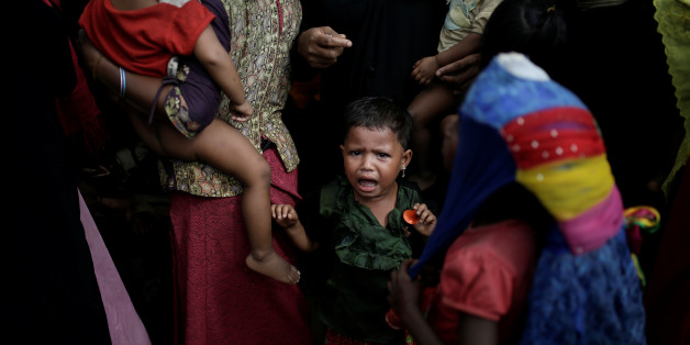 A baby cries as Rohingya refugees line up for a food supply distribution at the Kutupalong refugee camp near Cox's Bazar, Bangladesh December 12, 2017. REUTERS/Alkis Konstantinidis