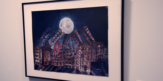 A painting by detainee Ahmed Robbani is viewed on November 22, 2017, part of an exhibit from Guantanamo Bay, Cuba at John Jay College of Criminal Justice in New York.The art is striking -- a miniature three-masted ship in cardboard, with bits of T-shirt for the sails and threads from a prayer cap for ropes. A picture of a huge mosque at water's edge. A shadowy and faceless Statue of Liberty.The pieces are all part of a surprising exhibit in New York with an unlikely source -- the US military pri