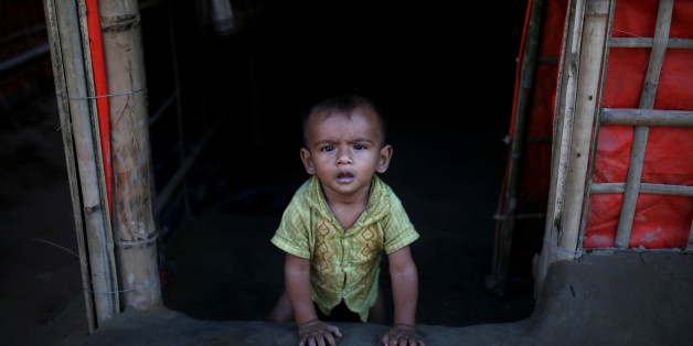 A Rohingya refugee baby sits at the entrance of his family's temporary shelter at the Onchiprang refugee camp near Cox's Bazar, Bangladesh December 13, 2017. REUTERS/Alkis Konstantinidis