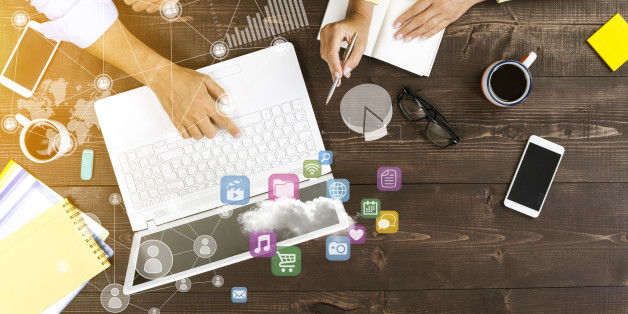 Two people working together on laptop at office with technological pattern